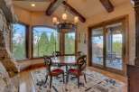 Experience breathtaking views from this elegant dining area, featuring a round wooden table with four ornate chairs perfect for intimate gatherings.