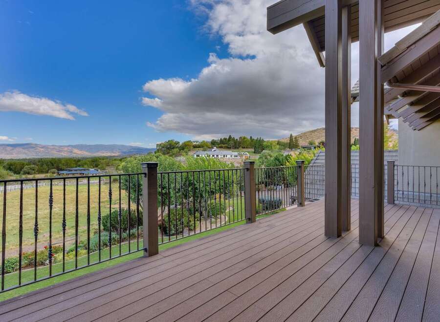 Enjoy breathtaking panoramic views from this expansive deck, perfect for entertaining or quiet relaxation.