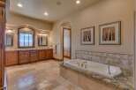 Indulge in luxury in this spacious master bathroom, featuring a deep soaking tub perfect for relaxation.