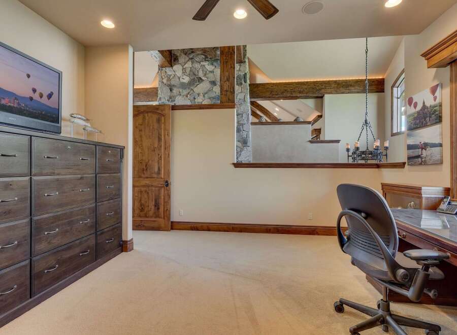 This spacious room offers a dedicated workspace with a large desk and comfortable office chair, perfect for productivity.