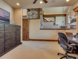 This spacious room offers a dedicated workspace with a large desk and comfortable office chair, perfect for productivity.