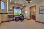 This home office features a large wooden desk with a computer and an ergonomic chair, perfect for productivity.
