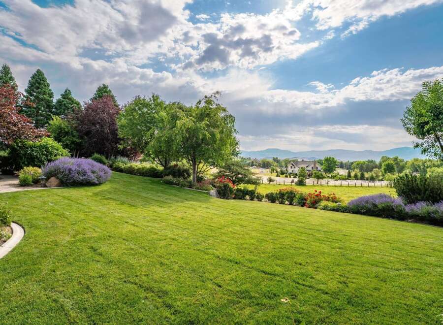 Experience the epitome of luxury living with this stunning property, boasting meticulously manicured lawns and vibrant floral arrangements.