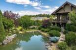 Experience luxurious living with this stunning property featuring a serene pond and lush landscaping, perfect for outdoor enjoyment.