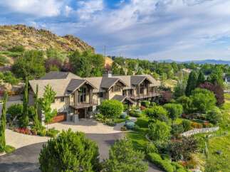 Experience luxury living in this stunning custom-built estate nestled against a scenic hillside.