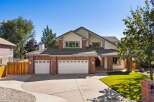 This stunning home boasts a charming brick exterior complemented by a spacious three-car garage, perfect for any car enthusiast.
