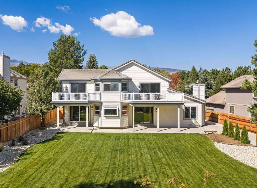 This stunning home boasts a spacious backyard with a meticulously manicured lawn, perfect for outdoor activities and entertaining.
