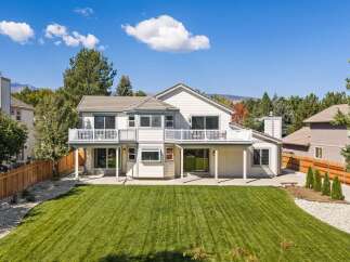 This stunning home boasts a spacious backyard with a meticulously manicured lawn, perfect for outdoor activities and entertaining.