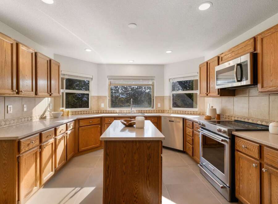 This spacious kitchen boasts beautiful oak cabinetry and ample counter space, perfect for meal preparation and entertaining.
