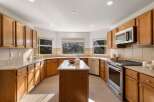 This spacious kitchen boasts beautiful oak cabinetry and ample counter space, perfect for meal preparation and entertaining.