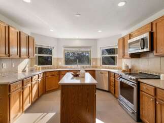 This spacious kitchen boasts beautiful oak cabinetry and ample counter space, perfect for meal preparation and entertaining.