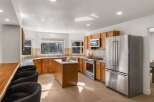 This spacious kitchen boasts beautiful oak cabinetry and a large central island, perfect for meal preparation and casual dining.