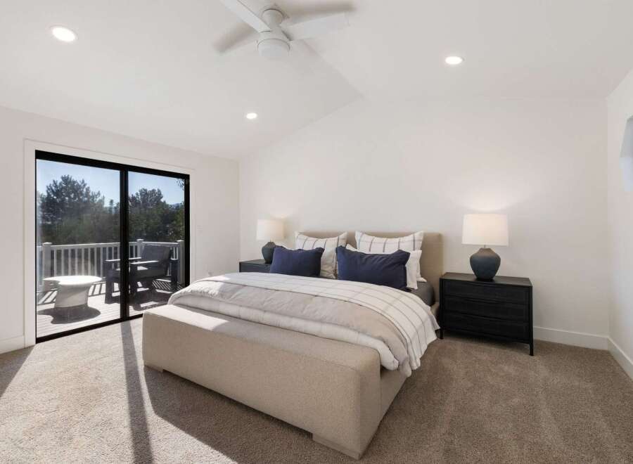 Experience luxury and comfort in this stunning bedroom featuring a king-sized bed adorned with plush pillows and a cozy duvet.