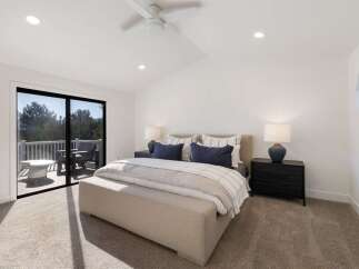Experience luxury and comfort in this stunning bedroom featuring a king-sized bed adorned with plush pillows and a cozy duvet.