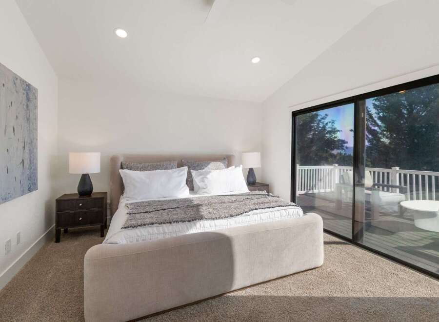 Experience luxurious living in this stunning bedroom featuring a plush king-sized bed and elegant nightstands.