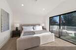 Experience luxurious living in this stunning bedroom featuring a plush king-sized bed and elegant nightstands.
