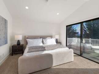 Experience luxurious living in this stunning bedroom featuring a plush king-sized bed and elegant nightstands.