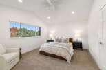 Experience serene living in this beautifully appointed bedroom, featuring a plush bed with elegant linens and two matching nightstands with lamps.
