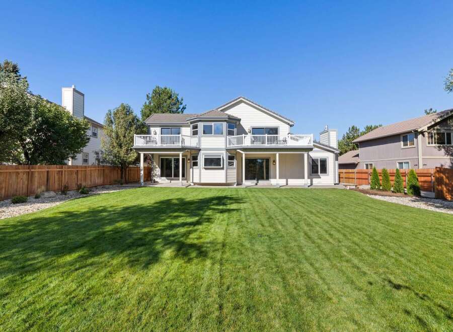 This stunning property boasts a spacious backyard with a meticulously manicured lawn, perfect for outdoor activities and entertaining.