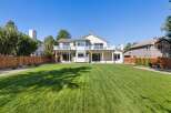 This stunning property boasts a spacious backyard with a meticulously manicured lawn, perfect for outdoor activities and entertaining.