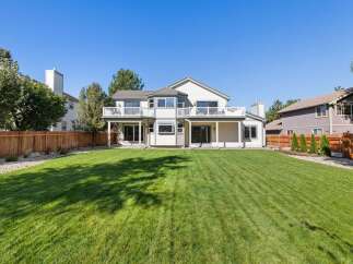 This stunning property boasts a spacious backyard with a meticulously manicured lawn, perfect for outdoor activities and entertaining.