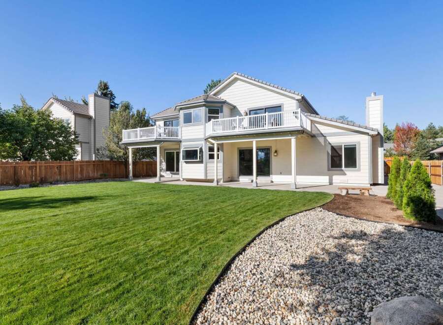 Enjoy outdoor living with this spacious backyard featuring a large, manicured lawn perfect for recreation.