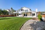 Enjoy outdoor living with this spacious backyard featuring a large, manicured lawn perfect for recreation.