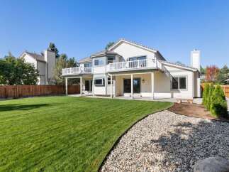 Enjoy outdoor living with this spacious backyard featuring a large, manicured lawn perfect for recreation.