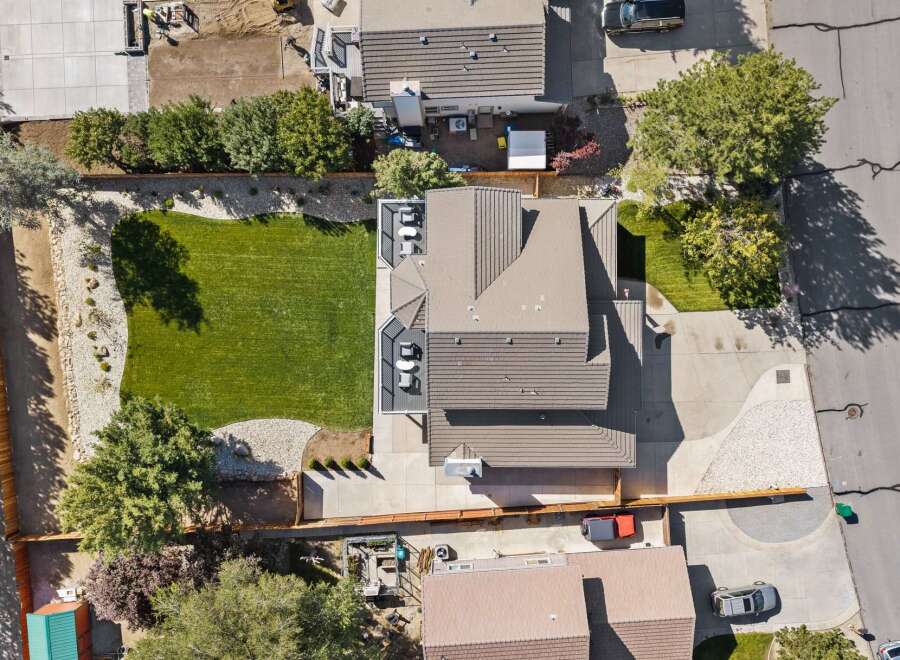 Discover this stunning aerial view of a modern home featuring a beautifully manicured lawn and a spacious backyard perfect for outdoor living.