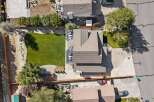 Discover this stunning aerial view of a modern home featuring a beautifully manicured lawn and a spacious backyard perfect for outdoor living.
