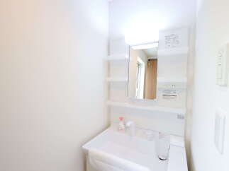 Discover modern convenience in this bathroom featuring a sleek vanity with a built-in sink and ample storage.