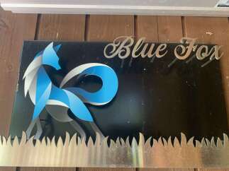 This unique property features a striking 'Blue Fox' sign, adding a touch of artistic flair to the exterior.