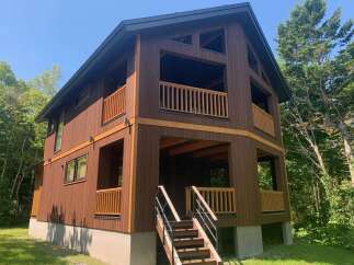 Discover this stunning modern cabin nestled amidst lush greenery.
