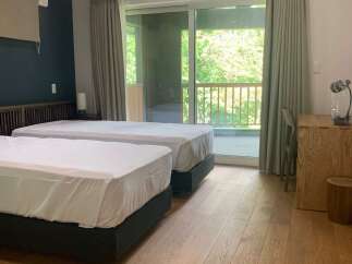 Experience serene living in this spacious room featuring two comfortable twin beds, perfect for accommodating guests or family.