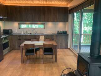 Experience cozy living in this charming kitchen featuring rich wood cabinetry and a sleek, modern design.