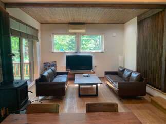 Experience modern living in this spacious living room featuring two plush leather sofas perfect for relaxation.