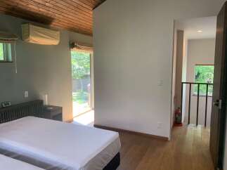 Experience comfort and style in this beautifully appointed bedroom, featuring a spacious bed and a modern air conditioning unit for optimal climate control.
