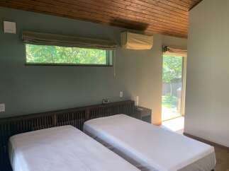 Experience serene living in this charming bedroom featuring two comfortable twin beds, perfect for guests or a shared space.