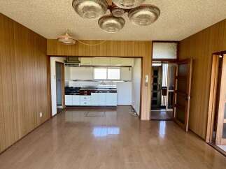 Step into this charming living space featuring warm wood-paneled walls and a bright, open layout.