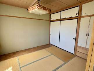 Discover this charming Japanese-style room featuring traditional tatami mat flooring and elegant shoji screen doors.