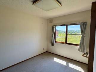 Discover a bright and airy room featuring a large window that floods the space with natural light.