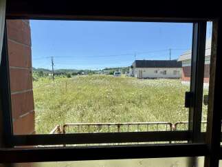 Experience the tranquility of this property, featuring a vast field of wildflowers stretching towards a clear blue sky.