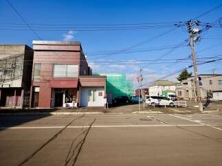 Discover this charming commercial property featuring a prominent brick facade and a welcoming awning, perfect for retail or boutique businesses.
