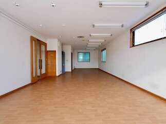 This spacious commercial space features a bright and airy interior with abundant natural light from large windows.