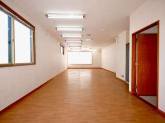 Discover this spacious and well-lit interior, featuring a long hallway with gleaming hardwood floors.