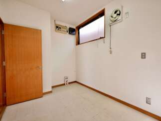 This image showcases a room with a wooden door and a long horizontal window.