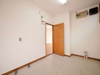 This empty room features a light-colored floor and white walls, offering a blank canvas for customization.