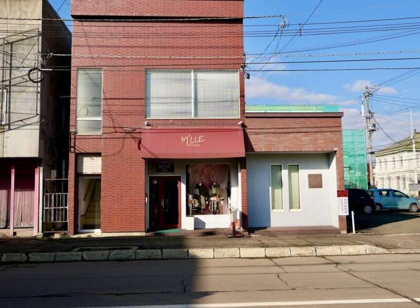 Discover this charming commercial property featuring a prominent storefront with a welcoming awning and display windows, perfect for retail or boutique businesses.