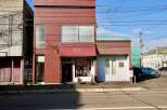 Discover this charming commercial property featuring a prominent storefront with a welcoming awning and display windows, perfect for retail or boutique businesses.