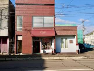 Discover this charming commercial property featuring a prominent storefront with a welcoming awning and display windows, perfect for retail or boutique businesses.